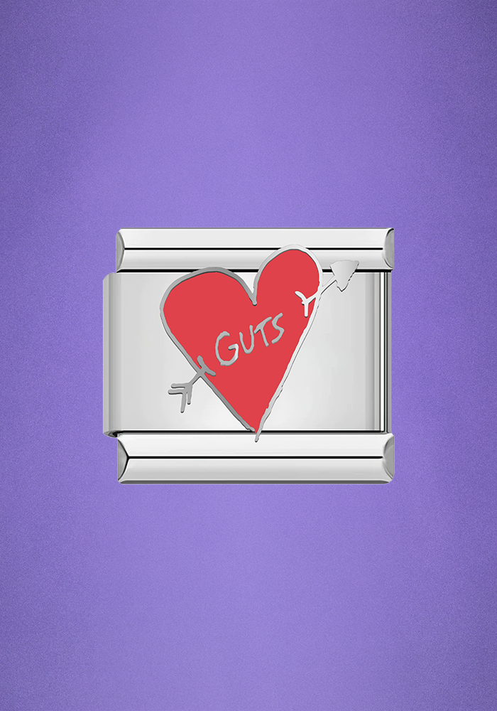 GUTS heart charm close up purple background