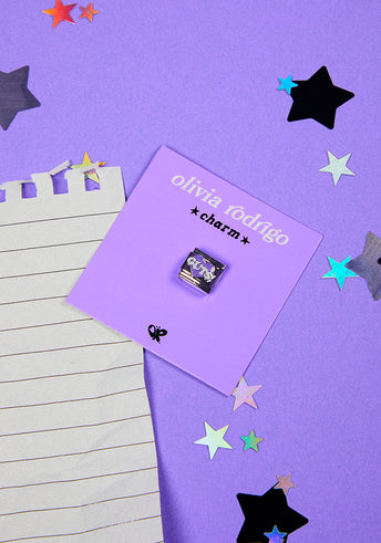 GUTS charm flat lay with glitter stars and notebook